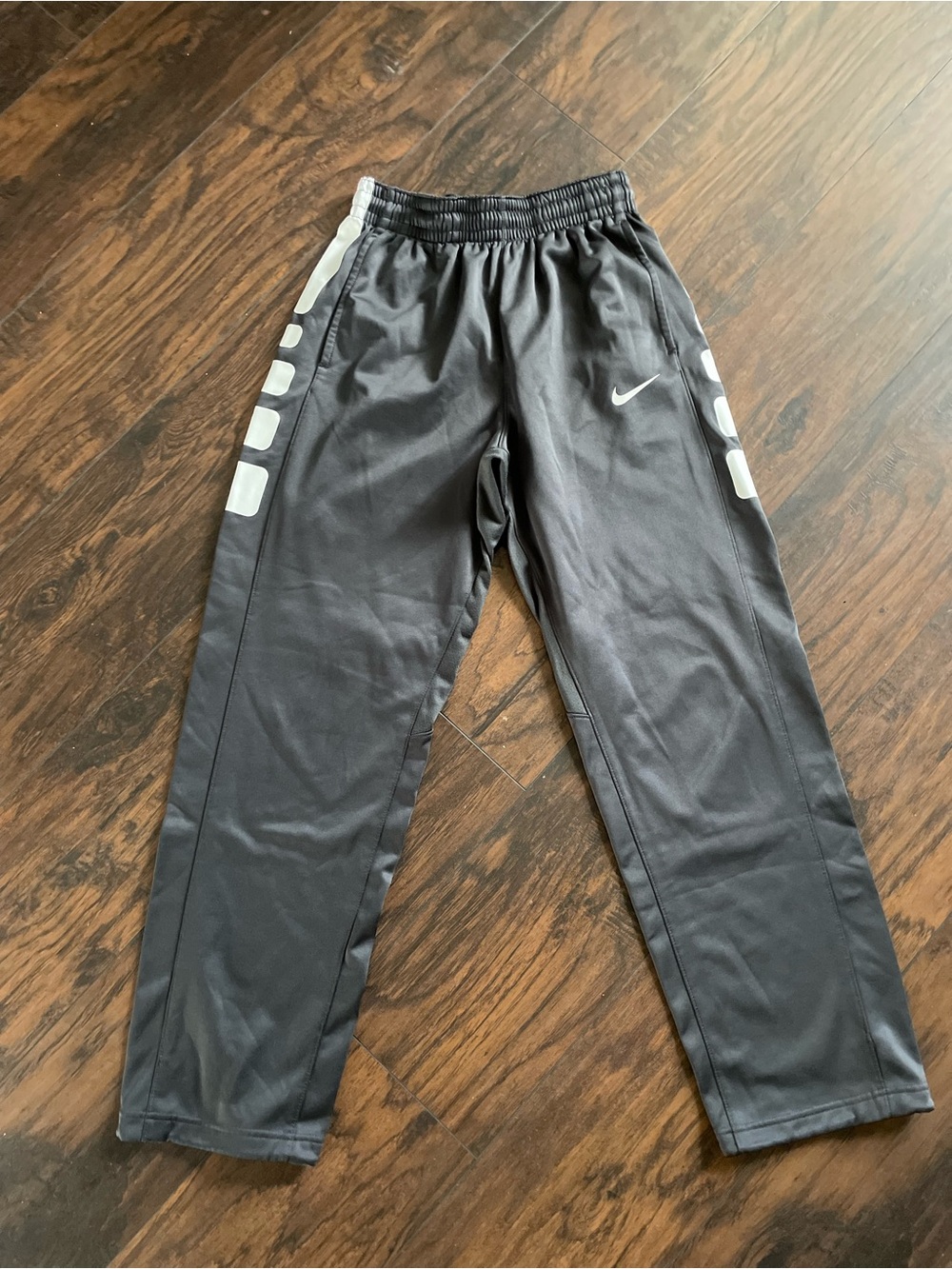 Nike Black Track Pants with White Swoosh and Side Panels
